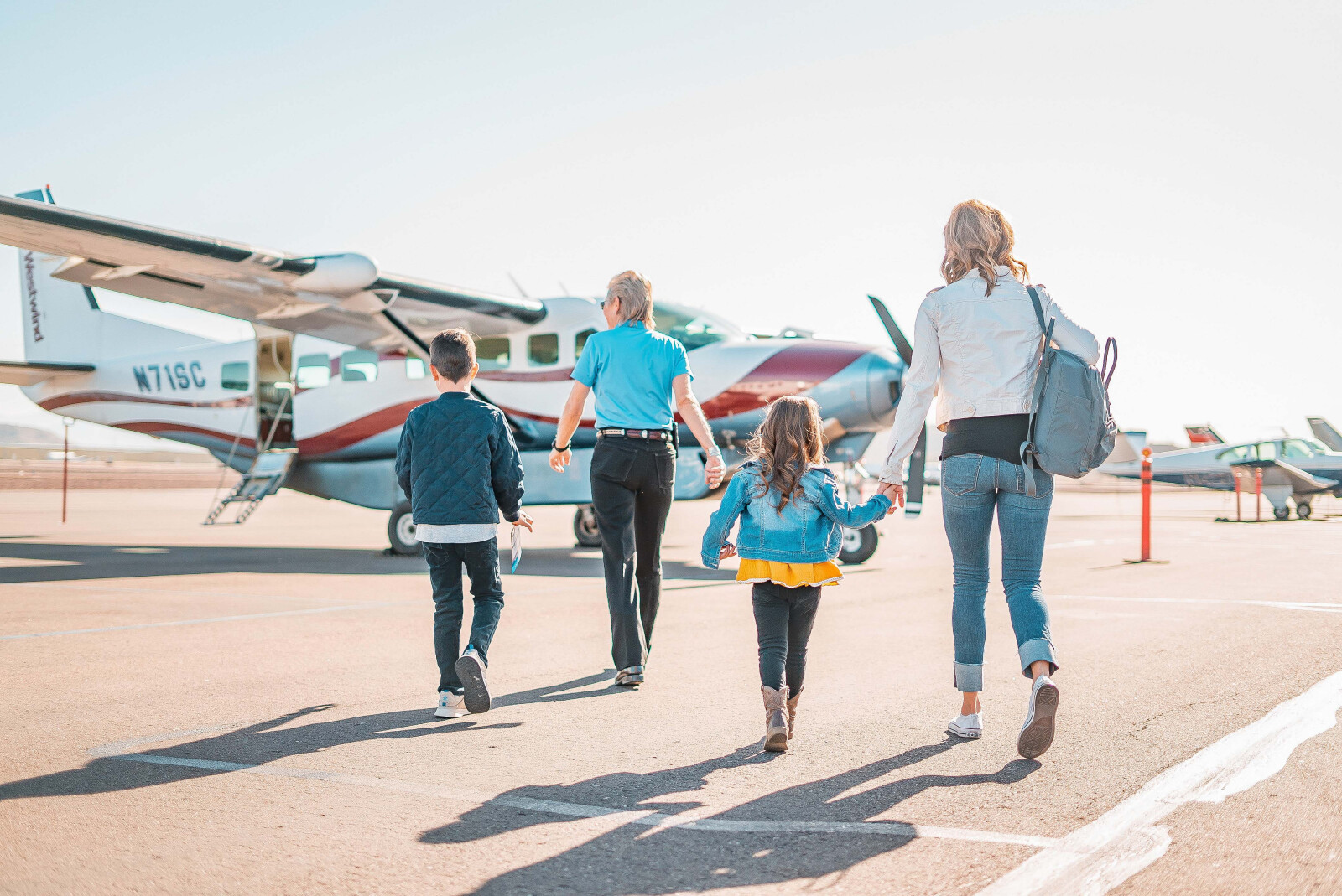 family walking to airplane